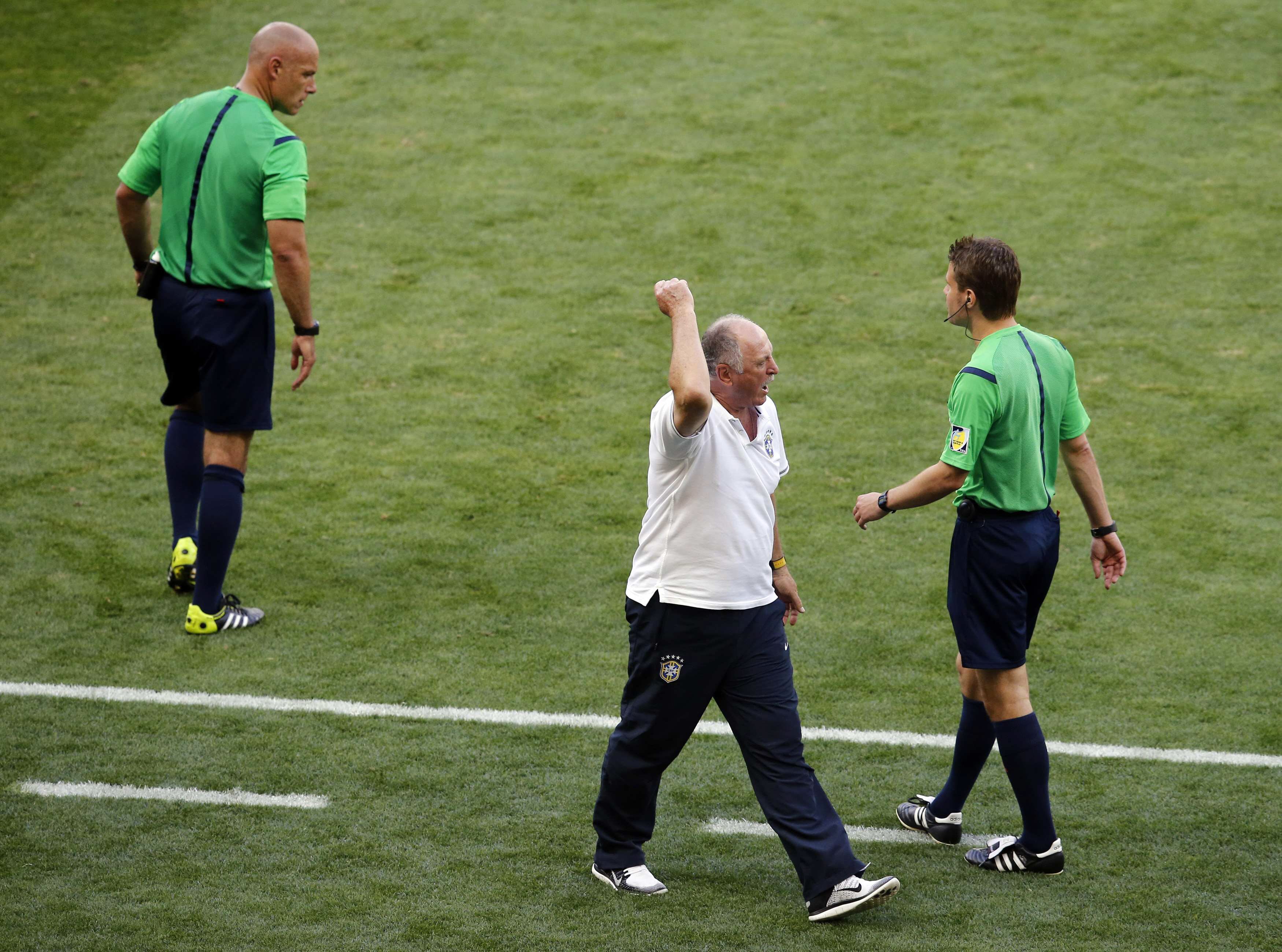 Brazil's coach Scolari reacts past referee Webb of England during their 2014 World Cup round of 16 game against Chile at the Mineirao stadium in Belo Horizonte